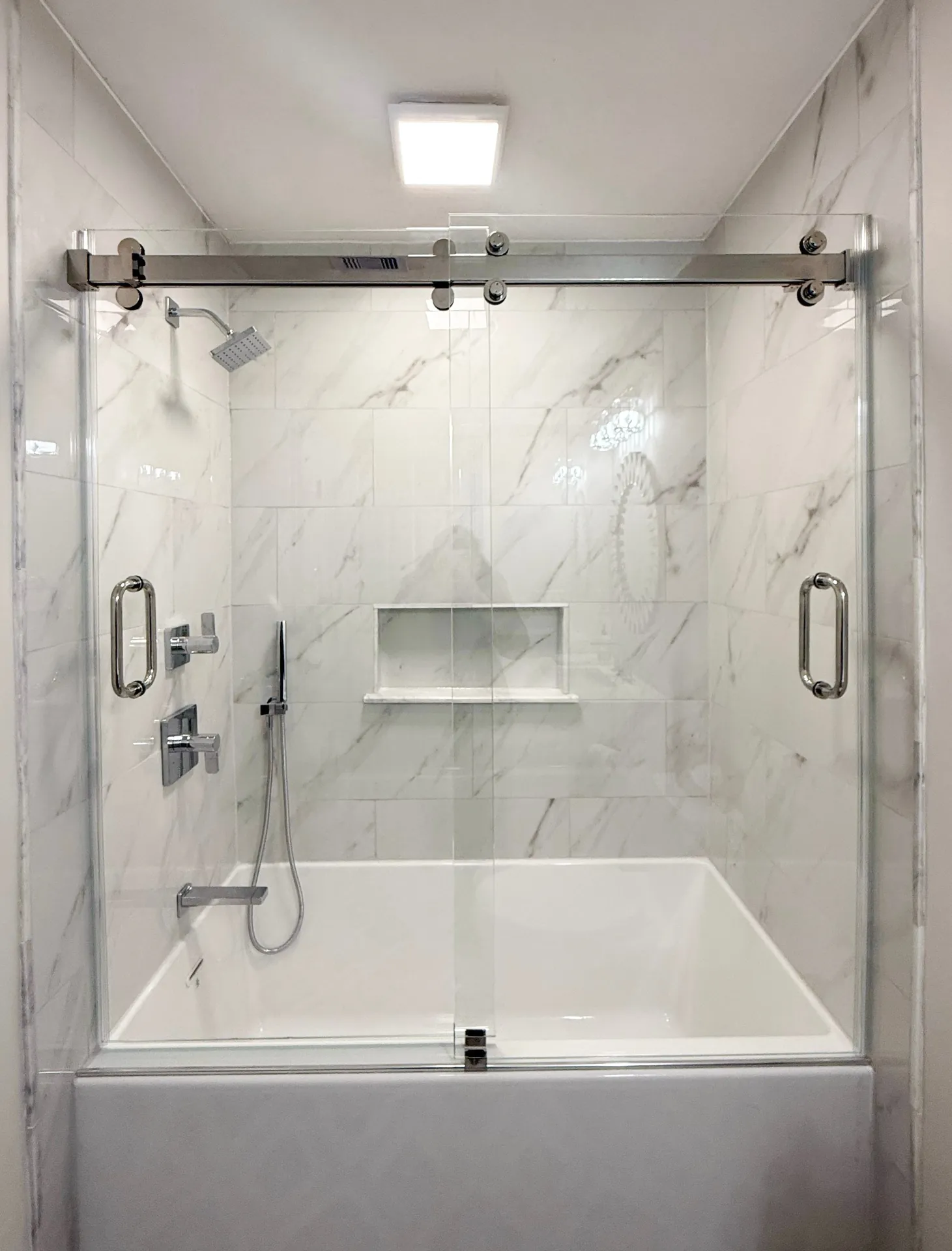 Sliding glass shower door on bathtub