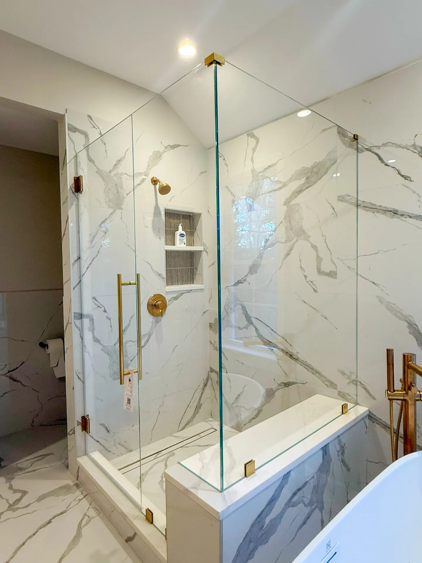 Marble bathroom with frameless glass enclosure